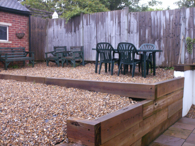 Pebble garden and patio wooden sleeper wall  107